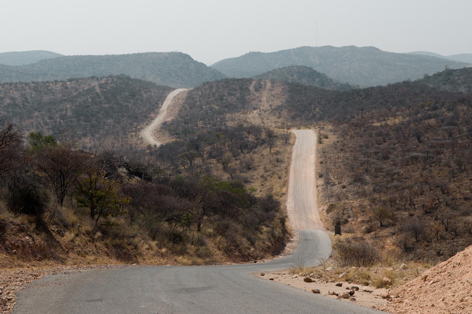 Gravel-road-between-Opuwo-and-Sesfontein-at-Joubert-Pass-Namibia_67672108 Road between Opuwo and Sesfontein